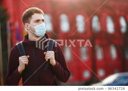 Portrait of men in protective sterile medical mask on her face on the street city. pandemic in quarantine city. 96342726