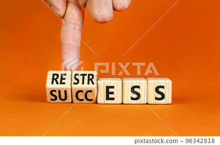 Restress for success symbol. Concept words Restress and Success on wooden cubes. Businessman hand. Beautiful orange table orange background. Business restress for success concept. Copy space. 96342818