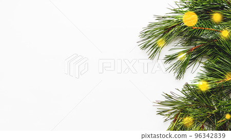 Festive banner with pine tree branches and light bulbs bokeh. White background with copy space and decorations for Christmas and New Year celebration. Festive banner with pine tree branches and light bulbs bokeh. White background with copy space and decorations for Christmas and New Year celebration. 96342839