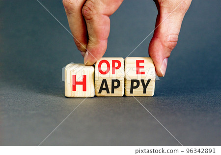 Hope and happy symbol. Concept words Hope and Happy on wooden cubes. Beautiful grey table grey background. Businessman hand. Business hope and happy concept. Copy space. 96342891