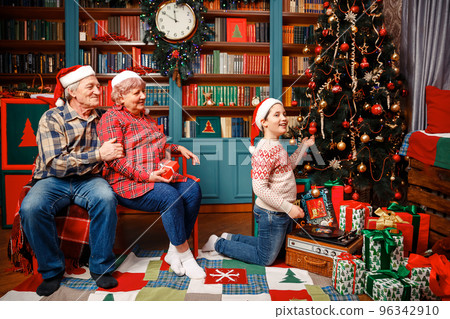 Family gift exchange tradition on christmas day at home. 96342910
