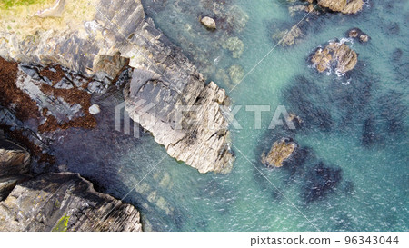 A lot of boulders in the sea water. Coastal cliffs of the North Atlantic. Seaside beautiful nature. Dramatic seascape of the north of Europe. Aerial photo. View from above. 96343044