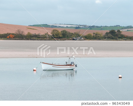 A motor boat. Calm water. Picturesque hills on the shore. The sandy shore of the Atlantic Ocean. 96343049