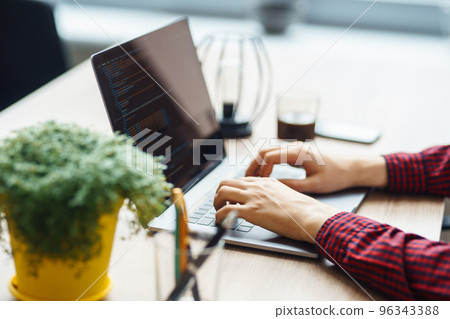 Close up picture of male hands working on her laptop. Social networking technology concept. Close up picture of male hands working on her laptop. Social networking technology concept. 96343388