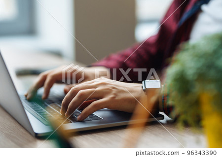 Close up picture of male hands working on her laptop. Social networking technology concept. Close up picture of male hands working on her laptop. Social networking technology concept. 96343390