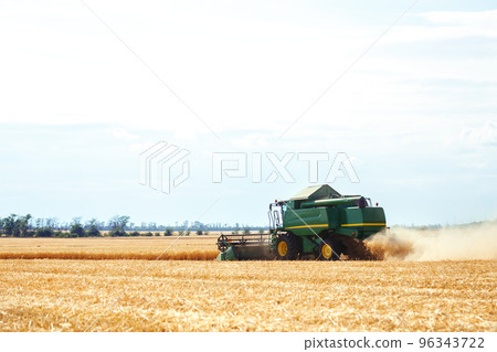 Time to harvest! Beautiful view of the work of the combine harvesting wheat. Harvester machine. Time to harvest! Beautiful view of the work of the combine harvesting wheat. Harvester machine. 96343722
