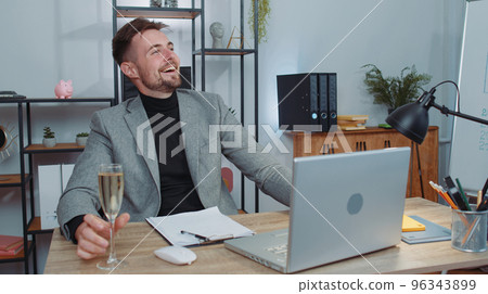 Businessman make video call conversation on laptop celebrate successful contract drinking champagne 96343899