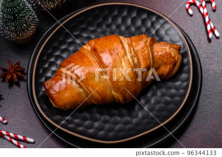 Beautiful different Christmas decorations and croissant on a brown concrete table 96344133