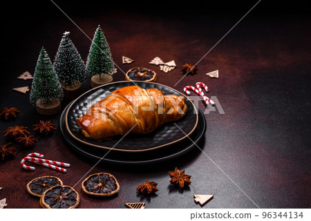 Beautiful different Christmas decorations and croissant on a brown concrete table 96344134