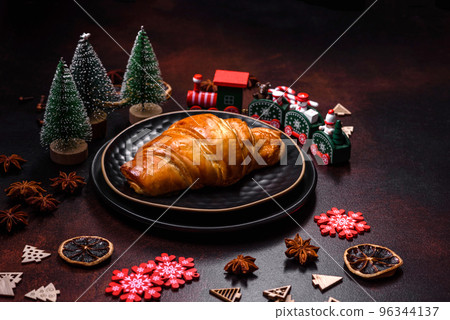 Beautiful different Christmas decorations and croissant on a brown concrete table 96344137