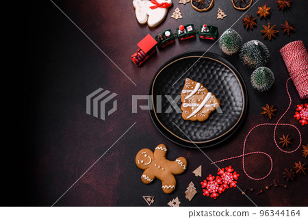 Beautiful different Christmas decorations and gingerbread on a brown concrete table 96344164