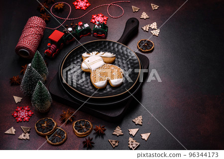Beautiful different Christmas decorations and gingerbread on a brown concrete table 96344173