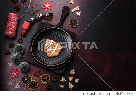 Beautiful different Christmas decorations and gingerbread on a brown concrete table 96344178
