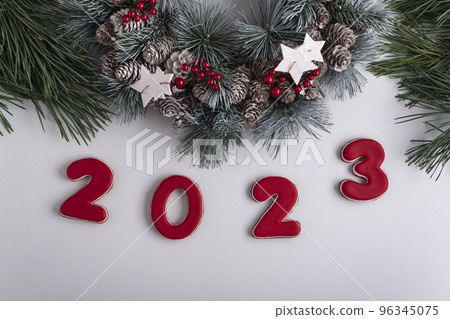 2023 inscription and Christmas wreath, top view. White background. Happy New Year 2023 96345075