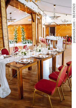 Beautiful table setting for a party, wedding reception or other festive event. Banquet setting, glasses, plates. Beautiful table setting for a party, wedding reception or other festive event. Banquet setting, glasses, plates. 96345920