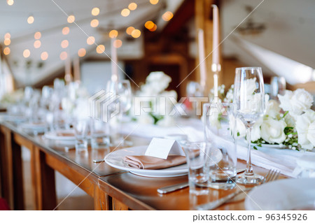 Beautiful table setting for a party, wedding reception or other festive event. Banquet setting, glasses, plates. Beautiful table setting for a party, wedding reception or other festive event. Banquet setting, glasses, plates. 96345926