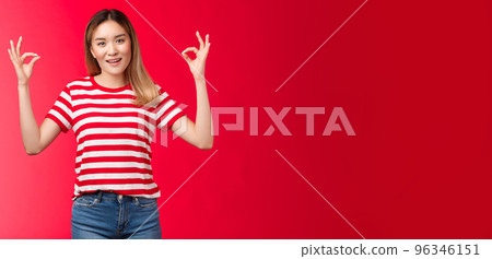 Optimistic good-looking modern asian blond girl show okay fine gesture assure everything ok, smiling broadly, give positive reply, agree good terms, approve excellent effort, red background Optimistic good-looking modern asian blond girl show okay fine gesture assure everything ok, smiling broadly, give positive reply, agree good terms, approve excellent effort, red background 96346151