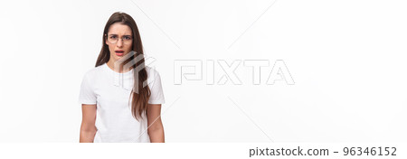 Waist-up portrait of frustrated and shocked young female coworker hear strange confession, freak out, frowning and grimaccing tensed and disappointed, dont agree and like idea, white background Waist-up portrait of frustrated and shocked young female coworker hear strange confession, freak out, frowning and grimaccing tensed and disappointed, dont agree and like idea, white background 96346152