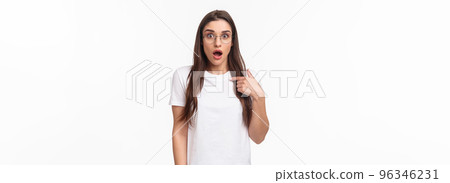 Portrait of surprised, startled young brunette female 20s in glasses, pointing at herself gasping and open mouth, widen eyes staring camera, being mentioned or chosen, picked from crowd 96346231