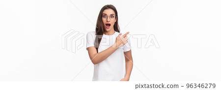 Waist-up portrait of enthusiastic, amazed and impressed young attractive girl in glasses talking about amazing new event or promo she saw online, pointing finger upper left corner, gasping astonished Waist-up portrait of enthusiastic, amazed and impressed young attractive girl in glasses talking about amazing new event or promo she saw online, pointing finger upper left corner, gasping astonished 96346279