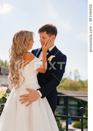 gentle and loving bride and groom in traditional wedding clothes on the terrace. gentle and loving bride and groom in traditional wedding clothes on the terrace. 96346608