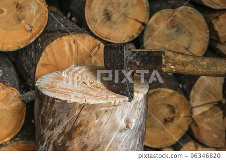 A man is chopping logs with an axe on chopping A man is chopping logs with an axe on chopping 96346820