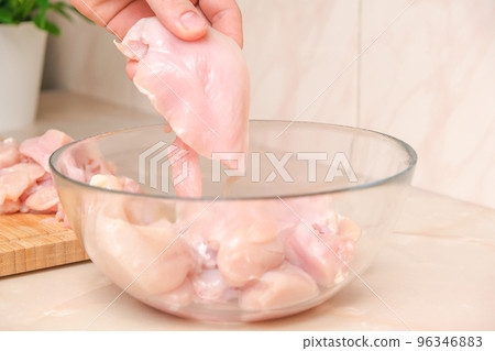Defrosted raw chicken fillet in a glass bowl 96346883