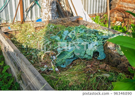 A compost heap in the village. Compost bin in the 96346890