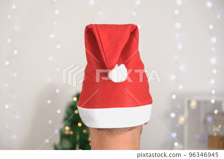 A man in a Christmas hat and a festive sweater on 96346945