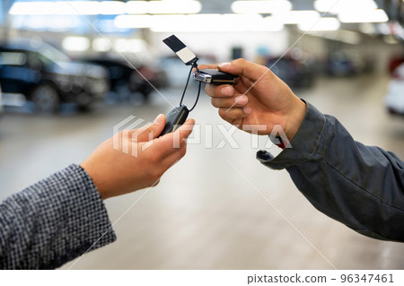 Car mechanic gives the keys to the customers who signed the purchase contract 96347461