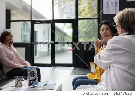 Medical specialist helping old patient with cervical collar removing neck brace after accident rehabilitation. Injured woman healing fracture and trauma and doing health checkup. Medicine concept Medical specialist helping old patient with cervical collar removing neck brace after accident rehabilitation. Injured woman healing fracture and trauma and doing health checkup. Medicine concept 96347650