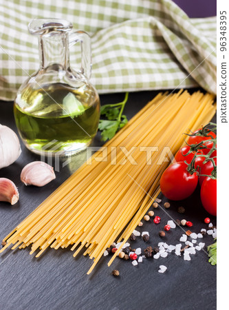 Pasta and food ingredients on black background. 96348395