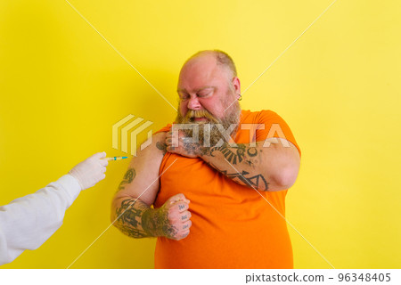 Thoughtful man is afraid of getting the covid-19 vaccine Thoughtful man is afraid of getting the covid-19 vaccine 96348405