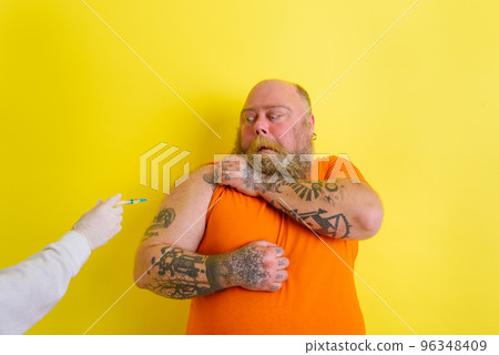 Afraid man is afraid of getting the covid-19 vaccine Afraid man is afraid of getting the covid-19 vaccine 96348409