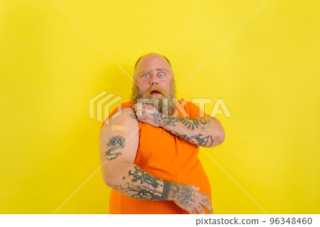 Amazed man with beard and tattoos did the vaccine against covid-19 Amazed man with beard and tattoos did the vaccine against covid-19 96348460