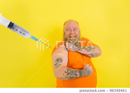 Happy man with beard and tattoos does the vaccine against covid-19 Happy man with beard and tattoos does the vaccine against covid-19 96348461