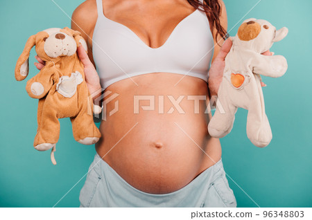 Pregnant woman expecting a child caresses her belly 96348803
