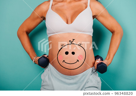 Pregnant woman expecting a child caresses her belly 96348820