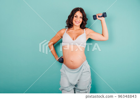 Pregnant woman expecting a child caresses her belly 96348843