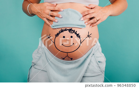 Pregnant mom prepares the clothes for the baby Pregnant mom prepares the clothes for the baby 96348850