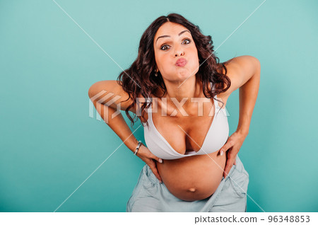Pregnant woman expecting a child caresses her belly 96348853