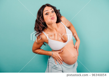 Pregnant woman expecting a child caresses her belly 96348854