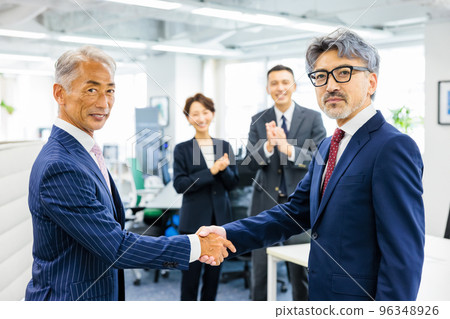 Business person shaking hands 96348926