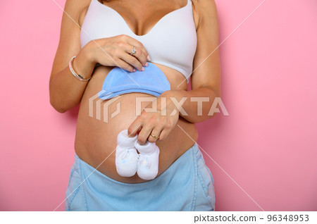 Pregnant mom prepares the clothes for the baby Pregnant mom prepares the clothes for the baby 96348953