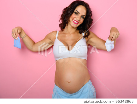 Pregnant mom prepares the clothes for the happy baby Pregnant mom prepares the clothes for the happy baby 96348963