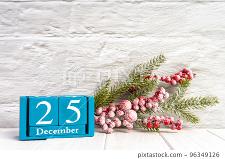 Christmas background with decorated fir tree and blue perpetual calendar with date Christmas background with decorated fir tree and blue perpetual calendar with date 96349126