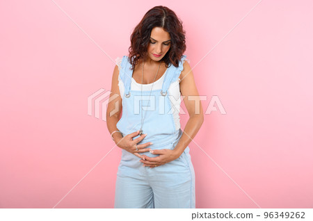 Pregnant woman expecting a child caresses her belly Pregnant woman expecting a child caresses her belly 96349262