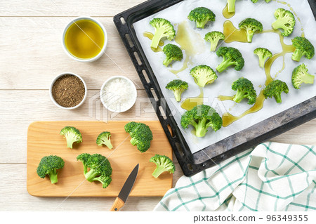 broccoli with olive oil and spice on baking tray, preparation for baking, top view. 96349355