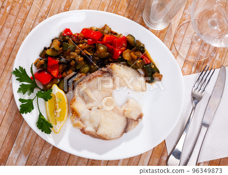 Prepared blue shark served with fried vegetables on plate on wooden table 96349873