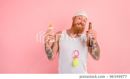 Thoughtful man with beard and tattoos acts like a newborn but wants a beer Thoughtful man with beard and tattoos acts like a newborn but wants a beer 96349977